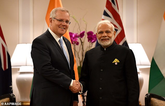 n officials (pictured with Indian Prime Minister Narendra Modi) asked the spies to leave Australia.