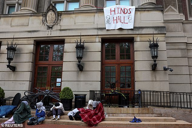 Student protesters sit and watch outside Hamilton Hall Tuesday morning.