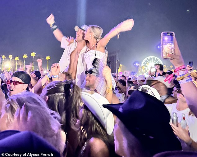 The 25-year-old star wore a white suit with her blonde hair tied back as she watched Morgan Wallen's troubled performance.