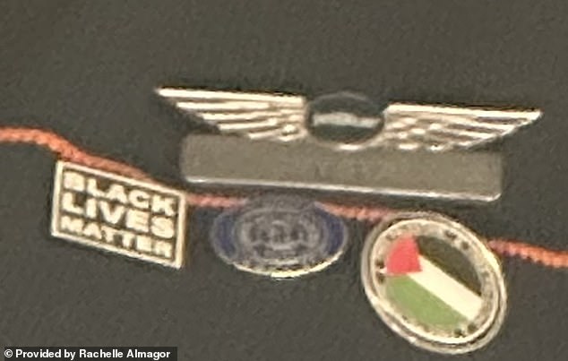 The airline attendant was wearing several pins, including a Palestinian flag and a Black Lives Matter badge.