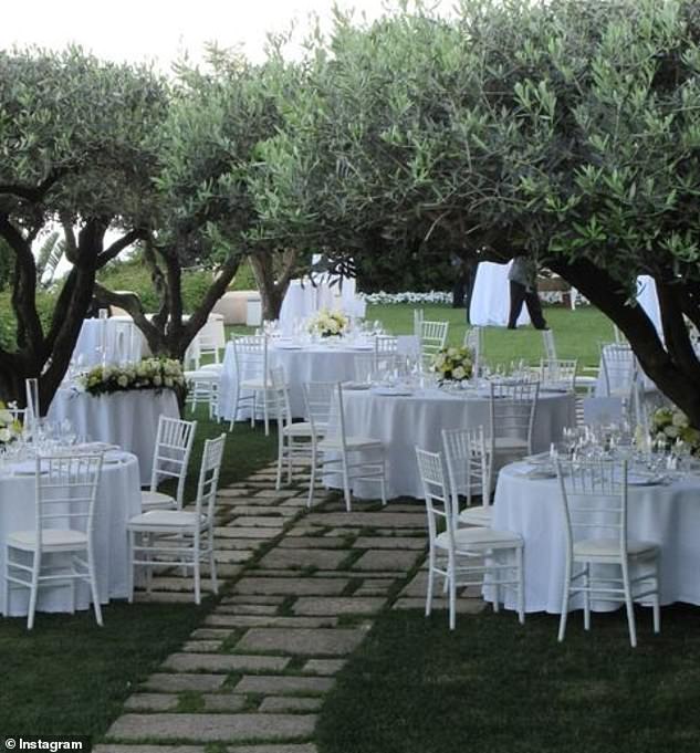 Dinner took place in a secluded garden overlooking the coast, with tables decorated with white tablecloths and flowers.