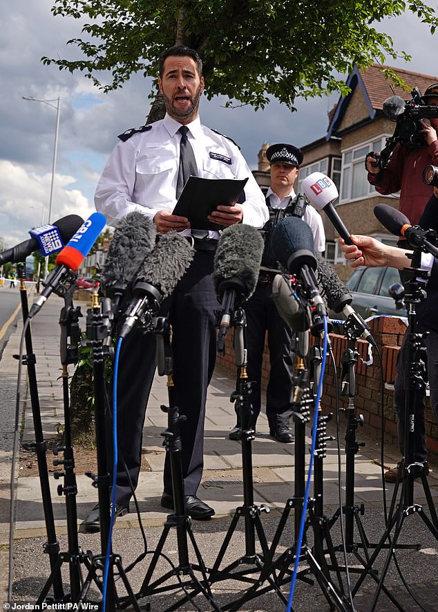Chief Superintendent Stuart Bell reads a statement to the media near the scene in Hainault, north east London, after the death of a child.