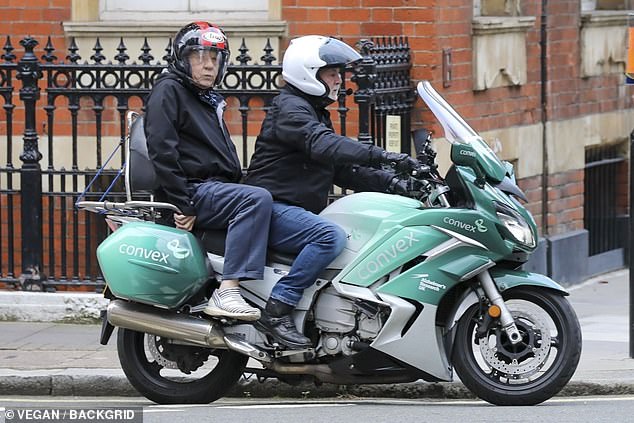 Sir Ian McKellen appears on the back of a motorcycle as he heads to his daily stage performance.