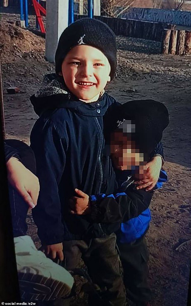 The body of little Artem Deriugin (pictured) was found covered in bruises in a washing machine in the garage of his home, two days after his grandfather reported him missing.