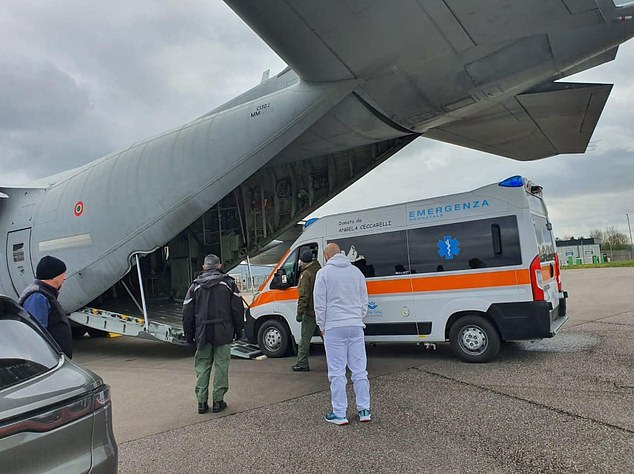 A specially modified ambulance being loaded onto a plane with military and medical personnel ready to fly to Bristol to collect the critically ill baby from Bristol Royal Hospital for Children.