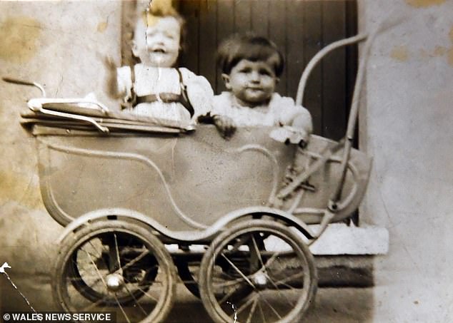 Brian and Margaret Main photographed as babies sharing a stroller during a walk