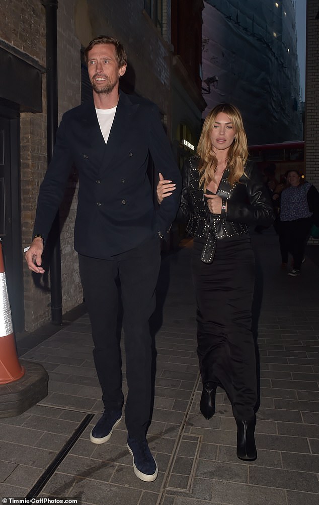 Abbey Clancy, 38, cut a chic figure in a sexy black dress as she left the star-studded McDonald's event at London's Outernet with her husband Peter, 43, on Wednesday.
