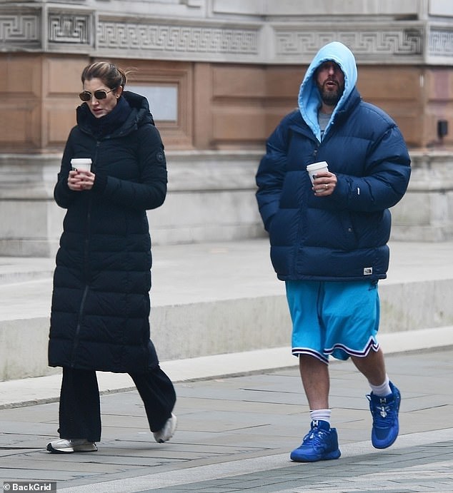 Adam Sandler, 57, bundled up in a £700 puffer coat while his wife Jackie kept warm in a £1,500 parka as they enjoyed a walk in cold London on Monday.