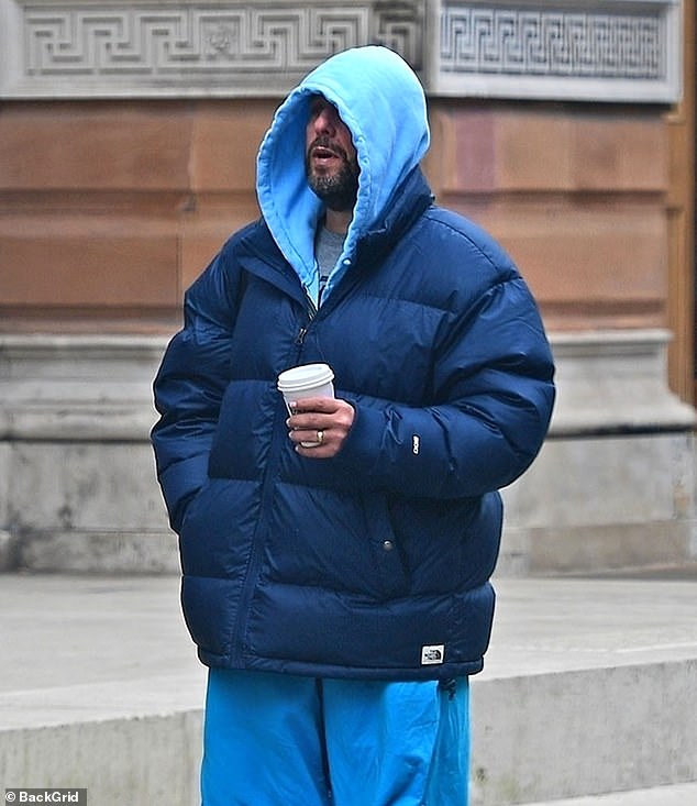 Despite the cold, he combined his huge coat with basketball shorts.