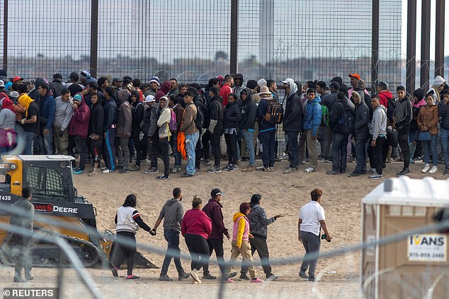 An Afghan migrant placed on the terrorist watch list spent a year in the United States after being released by Border Patrol, a shocking new report has revealed.  Immigrants seen queuing along the wall in Texas in March