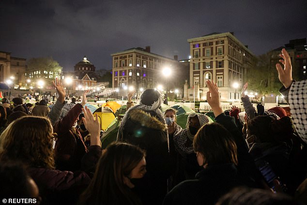 Students raise their hands to indicate whether they would be willing to take action that could lead to their arrest before the midnight deadline set by Columbia's president.