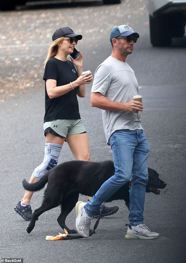 Despite needing a brace to go for a walk with her husband and dog, the media personality was all smiles during the outing.