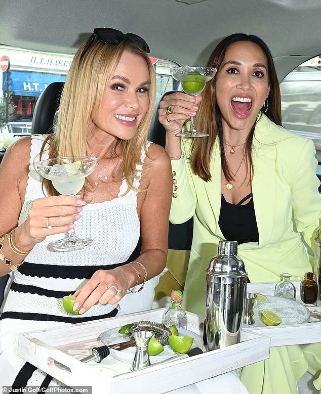 Amanda Holden (left) and Myleene Klass enjoyed a cheeky margarita in the back of a Lipsy brand taxi on Wednesday while celebrating their latest clothing line.