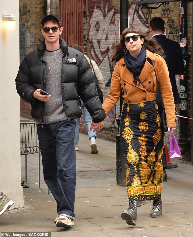 Andrew Garfield stepped out in London with his new girlfriend, 'Professional Witch' Dr Kate Tomas, as the pair explored central London hand in hand on Monday.