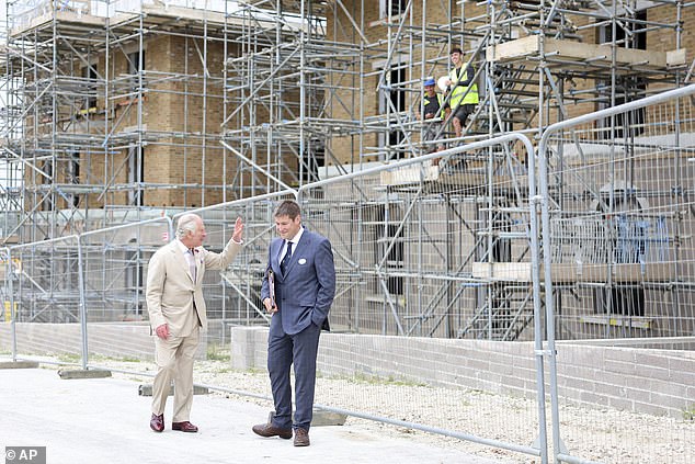 Locals have criticized plans proposed by King Charles to build 2,500 houses on 320 acres of farmland in a historic market town.  Pictured: King Charles III greets workers as he visits a construction site in Poundbury in June 2023.