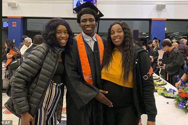 Dexter Reed, center, along with his mother Nicole Banks and sister Porsche Banks in 2019