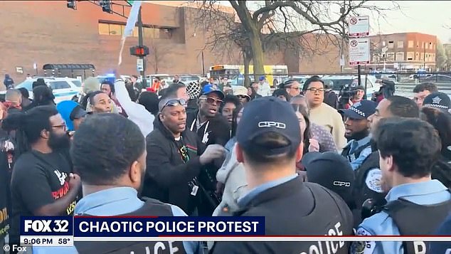 Angry BLM activists clashed with police outside a Chicago police station after video was released showing a fatal shooting of a black man by an officer.