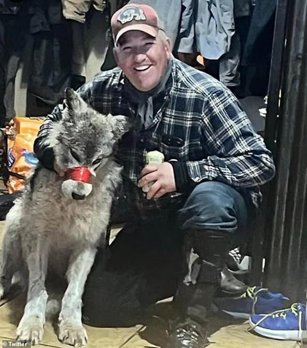 Roberts, 42, captured an injured wolf after hitting it with his snowmobile and paraded it around a local bar before killing it.  He is photographed with the animal.