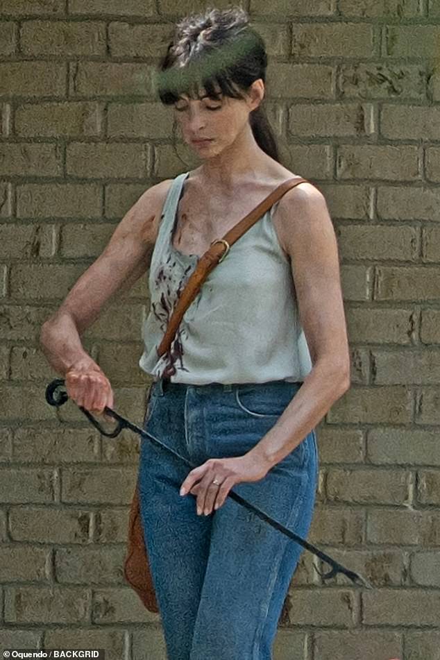 Anne Hathaway was splattered with fake blood and smeared with dirt while filming a scene for her sci-fi movie Flowervale Street in Atlanta this week.