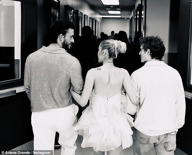Ariana Grande, 30, was photographed with her boyfriend and Wicked co-star Ethan Slater, 31, in a photo she posted to Instagram on Wednesday among a carousel of photos on the site.  She was also seen in the shot with Wicked actor Jonathan Bailey, 35.