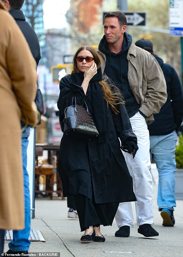 Ashley Olsen made the streets of New York City her runway when she stepped out with Nicholas Turko on Thursday.  The 37-year-old fashion designer and former actress looked effortlessly chic in an all-black ensemble and bundled up for the cold weather in an oversized trench coat.