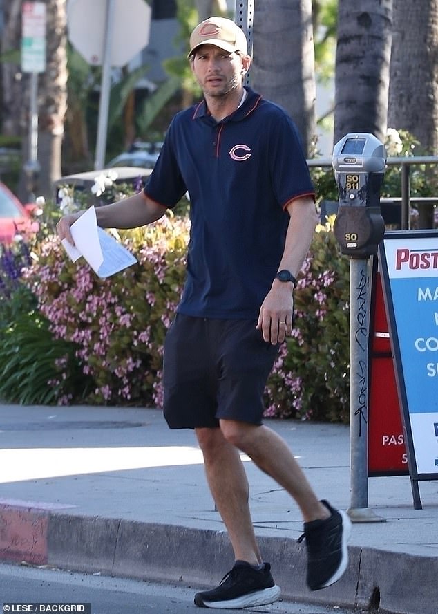 Ashton Kutcher was spotted running errands in Los Angeles this week.  The That 70s Show alum, 46, wore a navy Chicago Bears polo shirt with black shorts, a tan cap and black shoes.