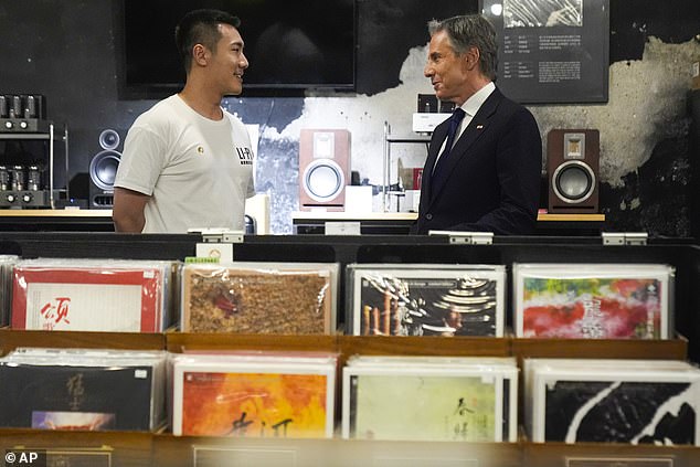 Secretary of State Antony Blinken talks with Yuxuan Zhou during a visit to the Li-Pi record store