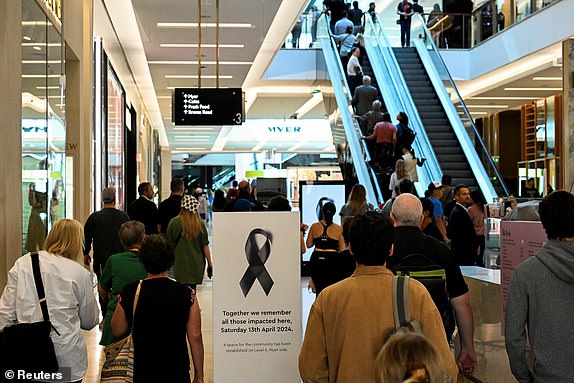 People walk on Community Reflection Day at the Westfield Bondi Junction shopping center as it reopens to the public for the first time after the stabbing attacks that killed several people at the shopping center, in Sydney, Australia, April 18, 2024. REUTERS/Jaimi Alegría