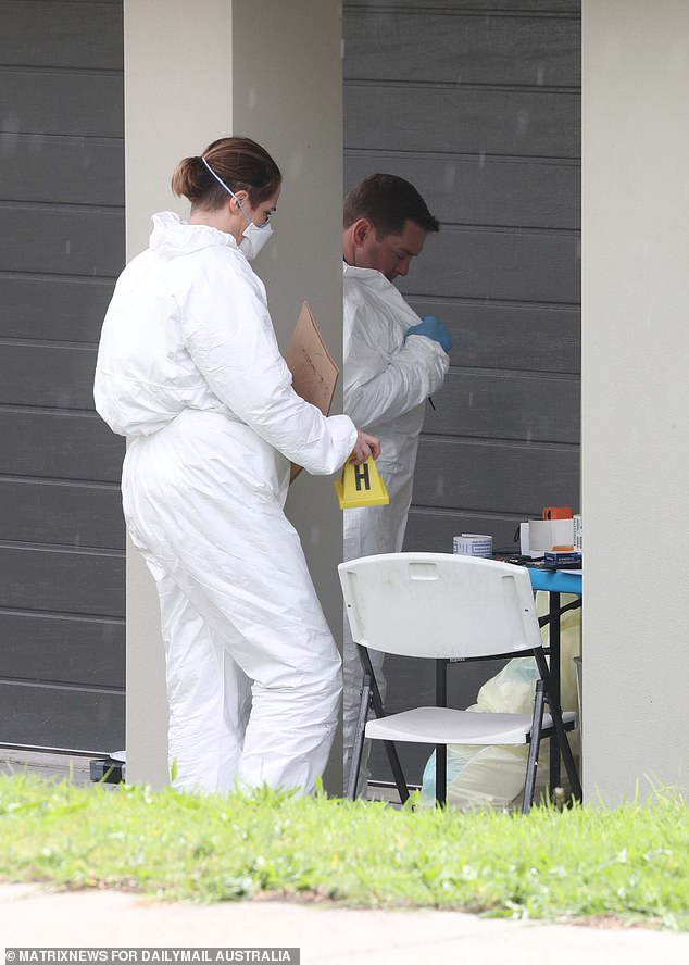 Pictured: Forensic investigators swarm the scene where a ten-year-old boy was allegedly murdered.