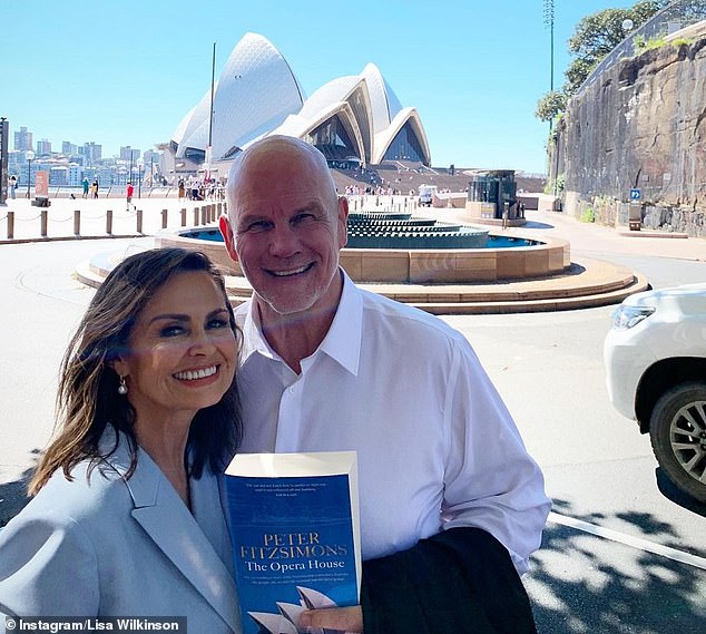Lisa Wilkinson is pictured with Peter FitzSimons, who is holding a copy of her book, 'The Opera House'.