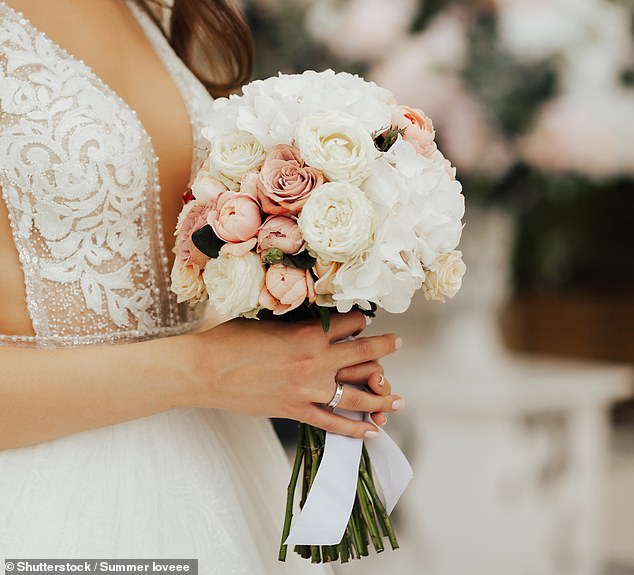 Wedding flowers can cost hundreds of dollars for a professional florist, but trying to grow your own flowers is a way to make your big day feel super personal and cut costs (File image of a bride holding her bridal bouquet)