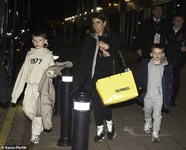 Coleen Rooney looked casual as she enjoyed an evening shopping trip with her husband Wayne and their four children on Tuesday.