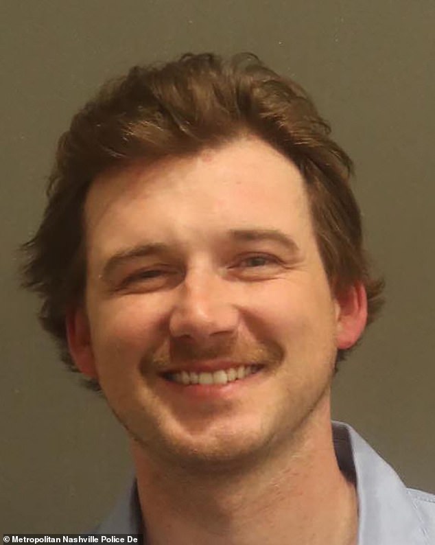 Country singer Morgan Wallen (pictured) appeared to be flirting with a woman minutes before throwing a chair from the roof of a Nashville bar.