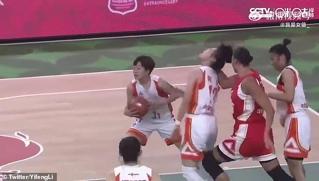 Cambage (second from right) can be seen punching an opponent in the face from behind during a match in China.