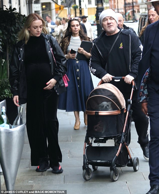Damien Hirst, 58, pushed his dog in a stroller as he was joined by his pregnant fiancée Sophie Cannell, 30, at Scotts in Mayfair on Friday.