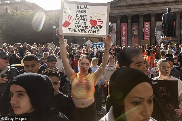 People gather at the State Library of Victoria to demonstrate against female violence