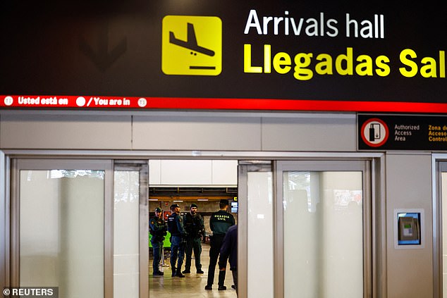The Spanish Civil Guard awaits Rubiales' arrival at Madrid airport on Wednesday
