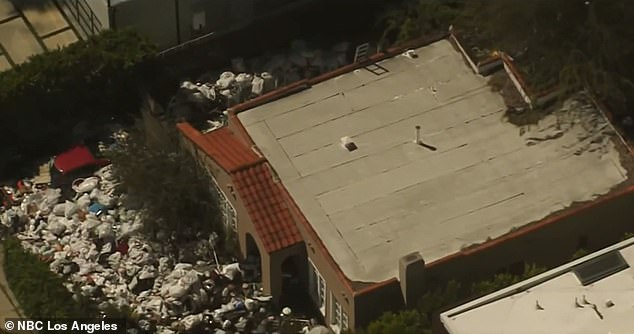 A Los Angeles home has been surrounded by a wall of trash after its owners refused to remove trash from the premises for eight years.