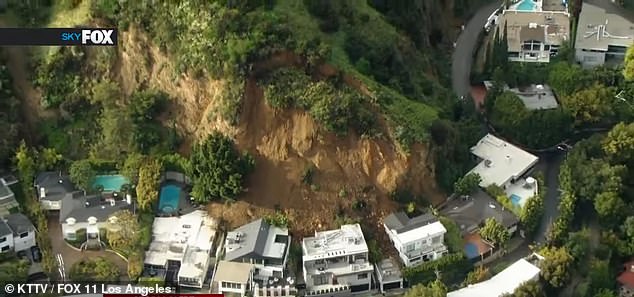 Three homes in Hollywood Hills, California, were damaged by a landslide (pictured) after torrential rains caused significant ground movement.