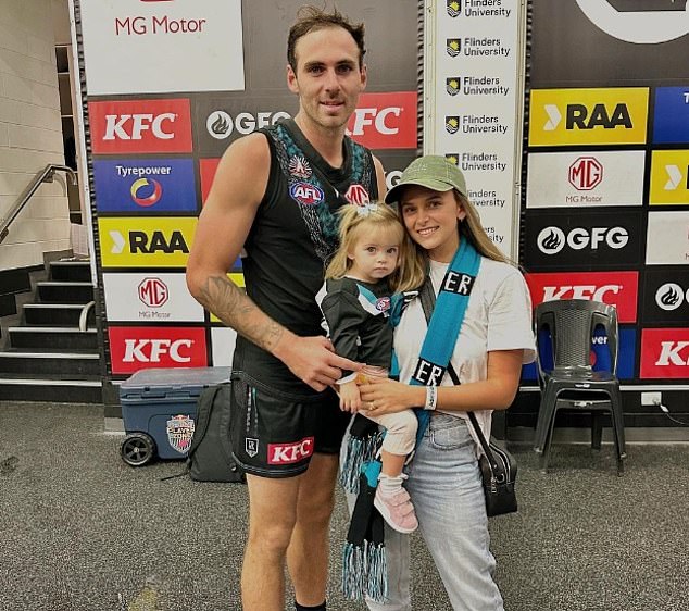 Finlayson with wife Kellie, who is battling stage four bowel cancer, and daughter Sophia in the sheds after a match at Port Adelaide.