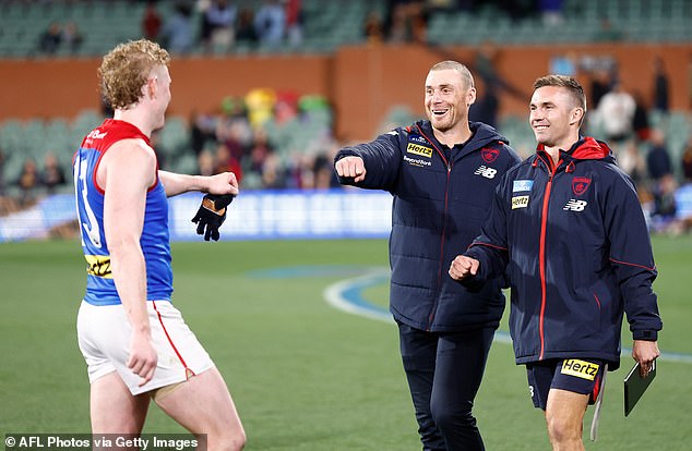 Demons coach Simon Goodwin (pictured center after the team's win over Adelaide on Thursday night) has come under fire from fans for a post-match comment.