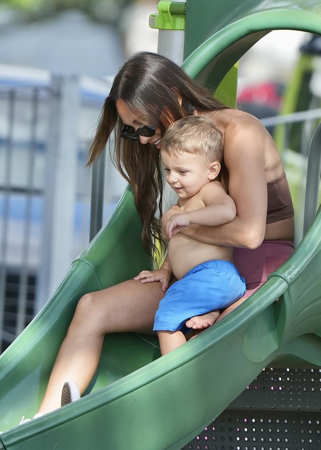 Kayla Itsines, 32, soaked up the sun in her new neighborhood on Sunday while spending time with her little ones on the Gold Coast.