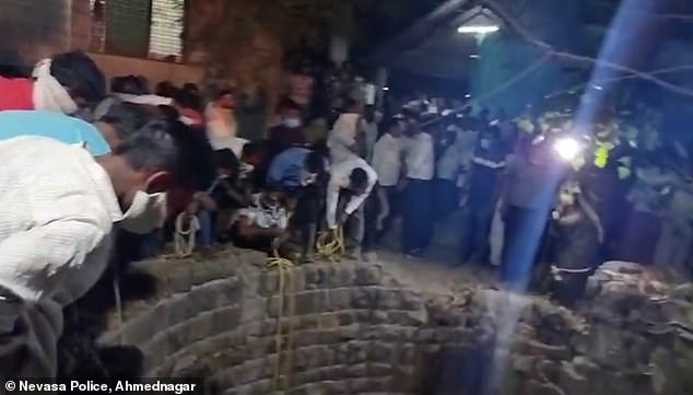 Footage shows worried villagers gathered around a biowaste pit in India after six people climbed inside to save a fallen cat.