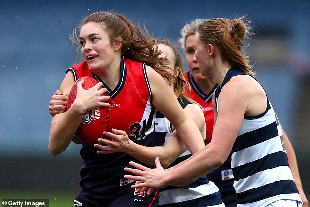 Essendon star Eloise Gardner (pictured left, holding ball) has hit back at Matthew Lloyd after the AFL legend criticized the league's controversial decision to ban skinfold testing.