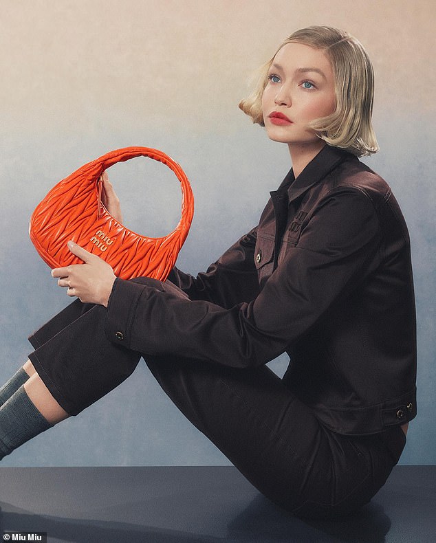 She modeled one of the brand's bold orange bags.