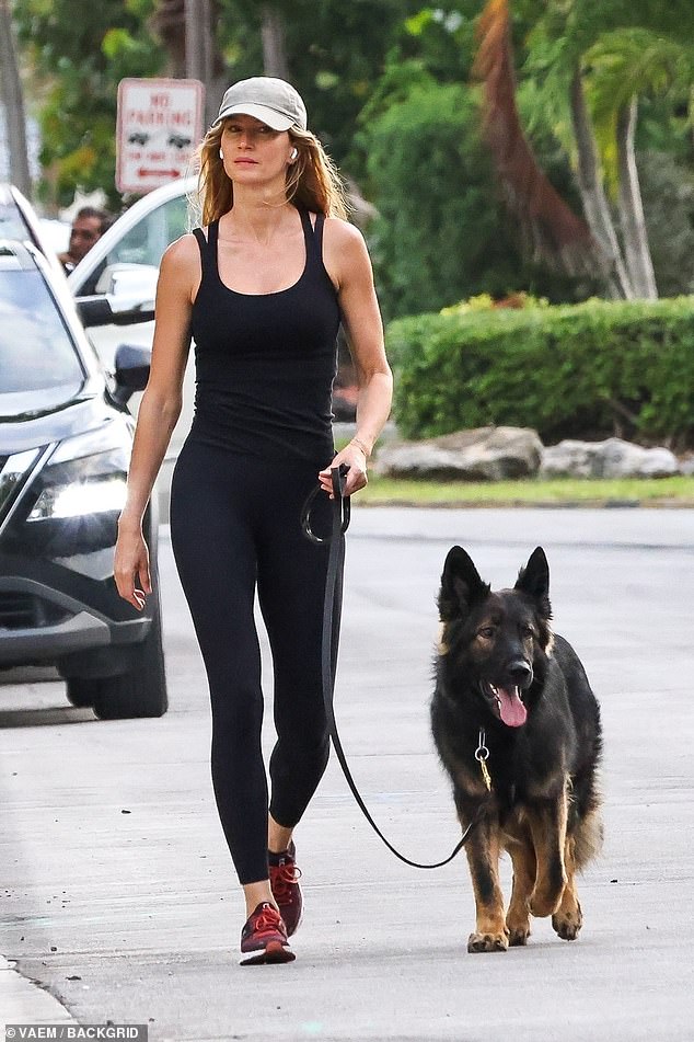 Gisele Bündchen looked every inch the doting dog mom while chatting with her beloved German Shepherd, Alfie, on a walk through her neighborhood in Miami, Florida.