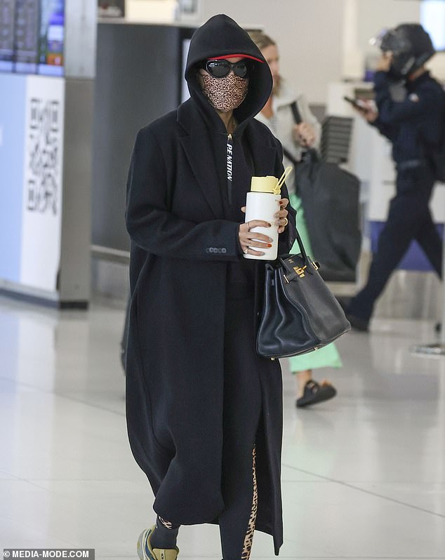 Rita Ora, 33 (pictured), made sure no one saw her as she left Sydney Airport on Sunday.