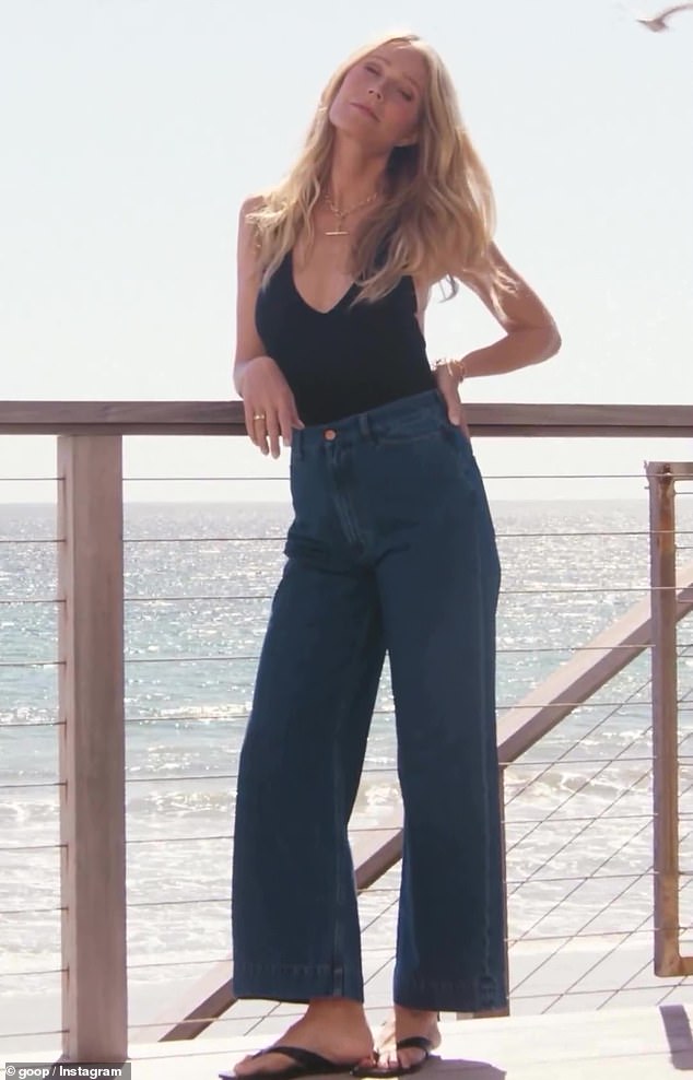 Pieces from her new collection include a low-cut black bodysuit, which Gwyneth tucked into baggy jeans for the shoot.