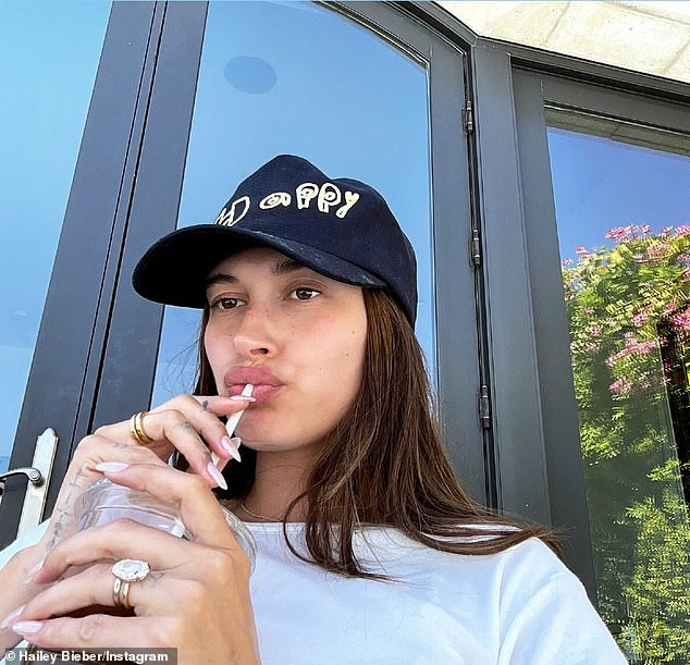 Hailey Baldwin Bieber donned her 'Happy' hat and showed off her $500,000 wedding ring in a new snap she posted on Instagram Wednesday to her 51.1 million captive followers amid divorce rumors.