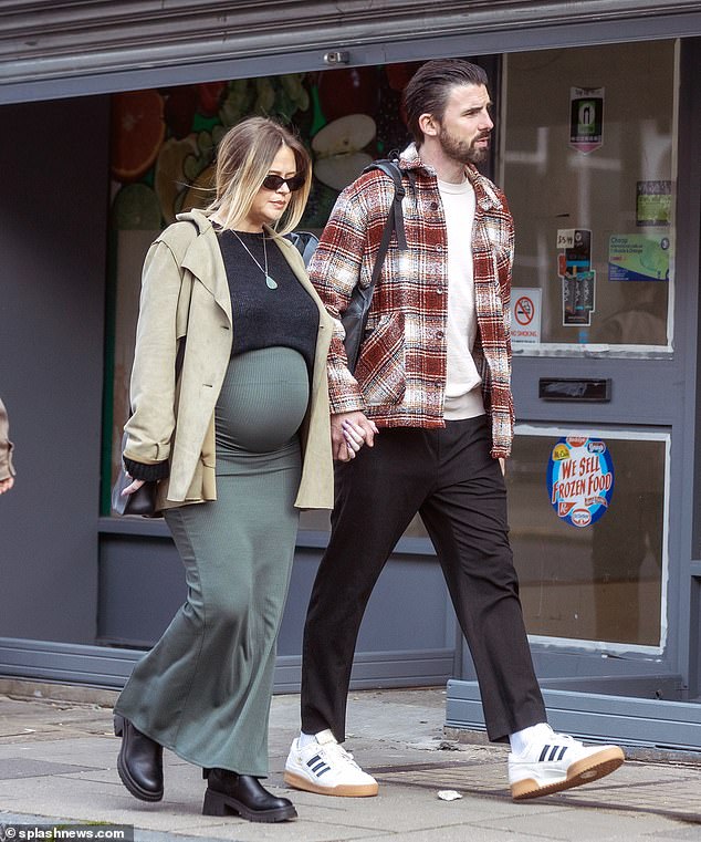 Emily Atack and her boyfriend Alistair Garner were spotted taking a walk in north London this weekend as they prepared to have their first child together.